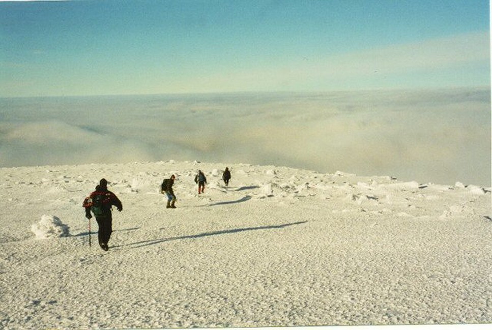 winter hikers above the clouds